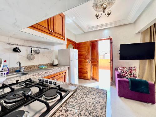 a kitchen with a stove top oven in a kitchen at SABOR FAMILY APARTS -Jaouharat Al Atlas in Marrakech