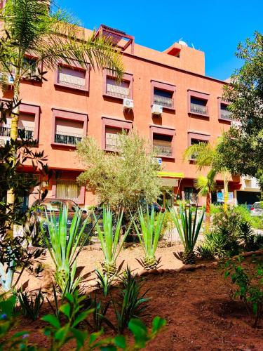 a building with a bunch of plants in front of it at SABOR FAMILY APARTS -Jaouharat Al Atlas in Marrakech