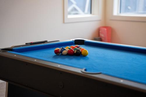 a pool table with balls on top of it at Mountain Retreat with Views, Hot Tub, Games & AC in Chilliwack