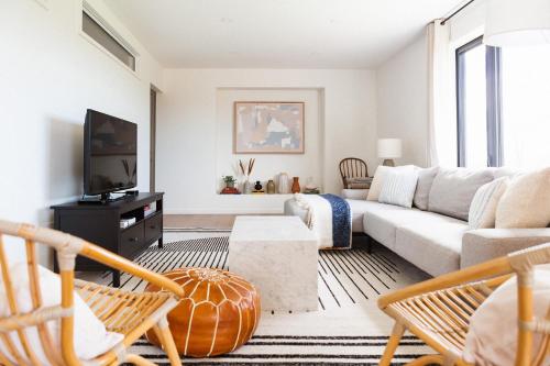 a living room with a couch and a tv at Old Milford - Modern Home 5 Minutes from Picton in Picton