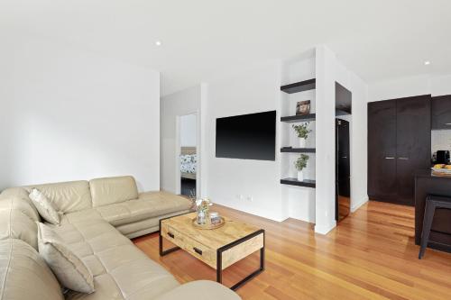 a living room with a couch and a table at Seagrove Retreat Cowes in Cowes
