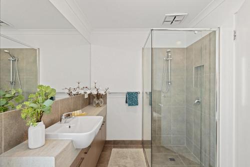 a bathroom with a sink and a shower at Seagrove Retreat Cowes in Cowes