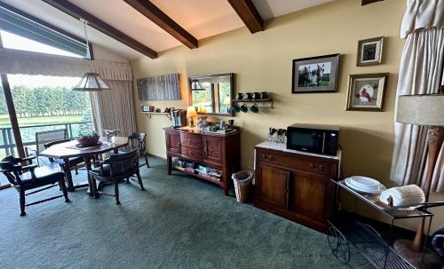 a living room with a table and a dining room at Pinehaven of Baraboo in Baraboo
