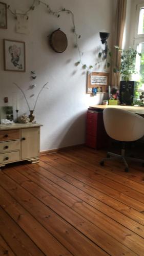ベルリンにあるHealing mindsetのデスクと椅子が備わるウッドフロアの客室です。