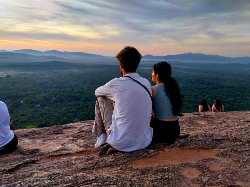 a group of people sitting on top of a mountain at Near The Canal Homstay in Sigiriya