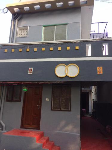 a house with two rings on the front of it at Arunachala foothills apartments in Tiruvannāmalai