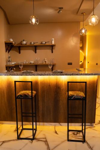 two bar stools at the counter of a restaurant at La Terrassa appartement climatisé in Azrou
