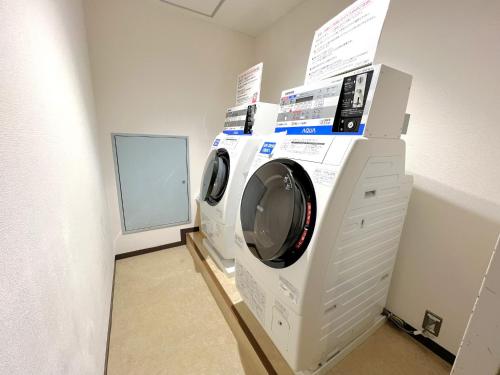 two washing machines stacked on top of each other in a room at Hotel Springs Makuhari in Chiba