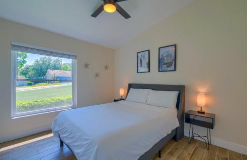a bedroom with a large bed and a window at New Resort Style Oasis ~ LED Pool & Game Room in Minneola