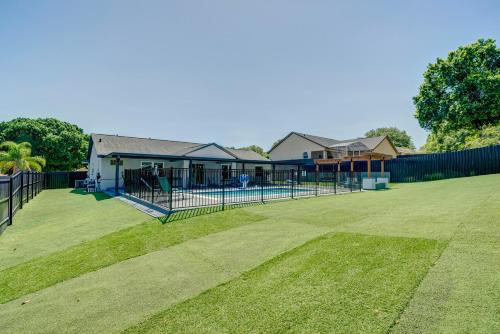 a yard with a fence and a tennis court at New Resort Style Oasis ~ LED Pool & Game Room in Minneola