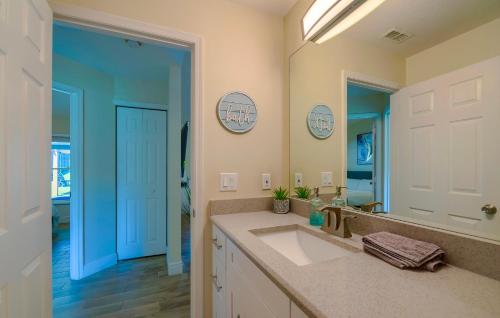 a bathroom with a sink and a mirror at New Resort Style Oasis ~ LED Pool & Game Room in Minneola