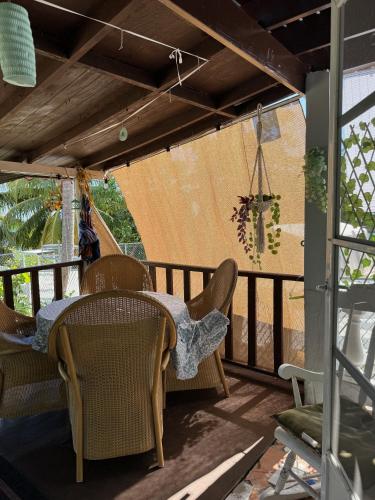a patio with a table and chairs on a porch at Bungalow Ocean View wifi in Patillas