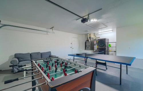 a room with two ping pong tables and a couch at New Resort Style Oasis ~ LED Pool & Game Room in Minneola