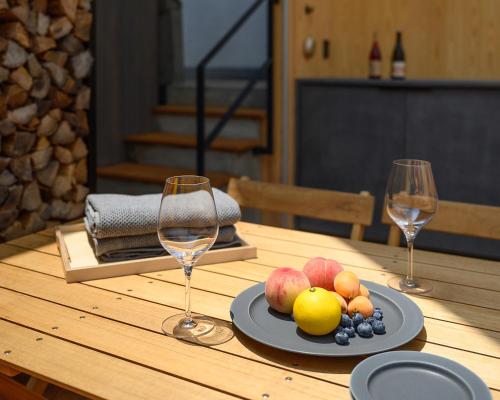 a table with two wine glasses and a plate of fruit at 穴吹邸 / ANABUKI-TEI in Takamatsu