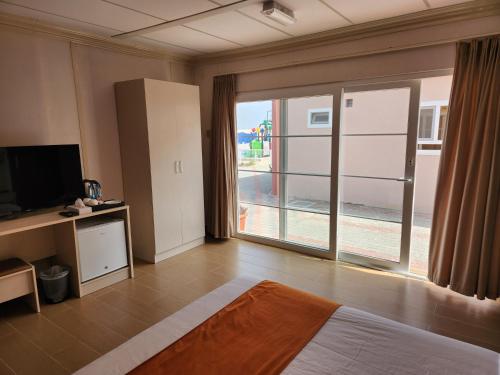 Habitación con cama y ventana grande. en Lina Dreamland Resort, en Billah