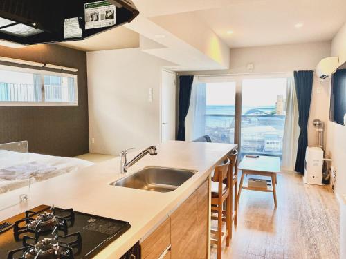 a kitchen with a sink and a counter top at Stay`sOTARU in Otaru