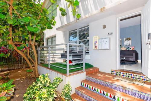 a house with a staircase leading to the front door at Sunny Days Apartments in Miami Beach