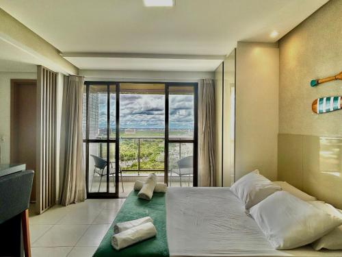 a bedroom with a large bed with a large window at (903) Studio exclusivo e clima tropical in Vinhais