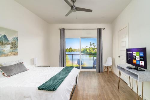 a bedroom with a bed and a desk with a computer at Waterfront Oasis with Bunk Room by SpaceX and SPI in Brownsville