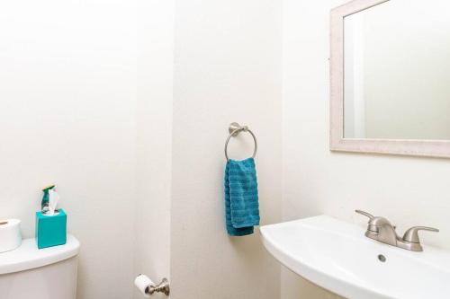 a white bathroom with a sink and a mirror at Waterfront Oasis with Bunk Room by SpaceX and SPI in Brownsville