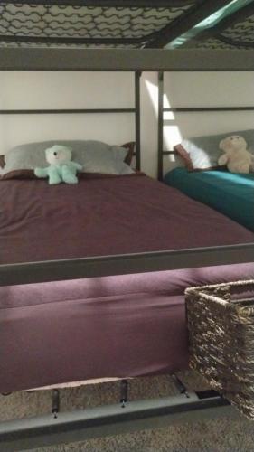 two teddy bears sitting on top of a bed at Travel Nurses Delight in De Land