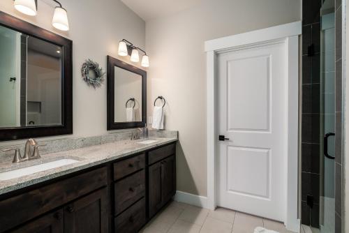 a bathroom with a sink and a mirror at Southbridge Cottage: Cozy and Modern Home in Bozeman