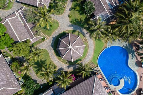 an overhead view of a swimming pool and palm trees at Anja Beach Resort & Spa in Phu Quoc