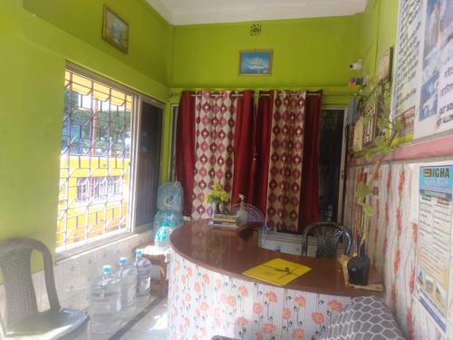 a kitchen with a counter and some windows at Hotel Milan Guest House Digha - Couple Friendly in Digha