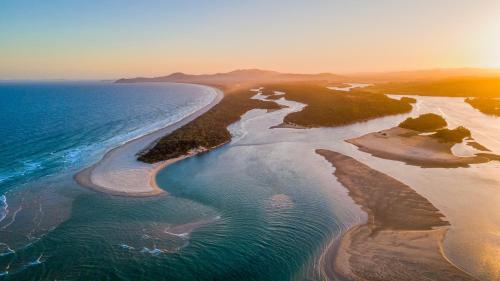 an aerial view of the ocean and a beach at BIG4 Tasman Holiday Parks - Nambucca Heads in Nambucca Heads