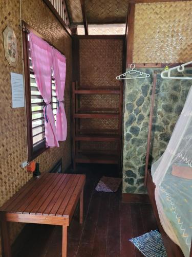 a room with a shower and a wooden bench in a room at MALAIKA RESORT in San Vicente