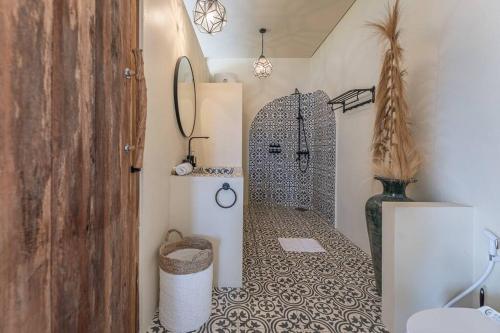 a bathroom with a shower with a tile floor at Stylish Tropical Villa in Uluwatu in Uluwatu