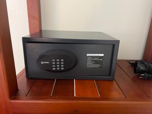 a microwave oven sitting on top of a wooden cabinet at Natural Relax Villa in Siem Reap