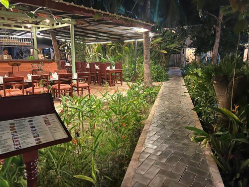 a patio with tables and chairs in a restaurant at Natural Relax Villa in Siem Reap