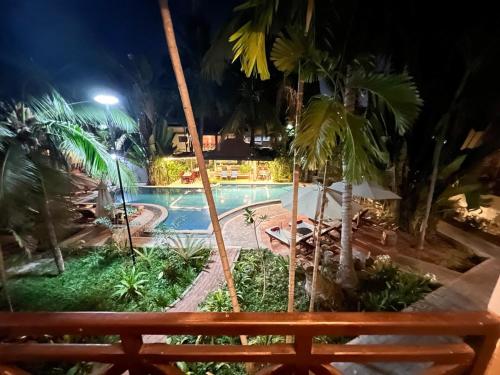 a view of a swimming pool at night at Natural Relax Villa in Siem Reap