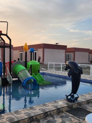 a swimming pool with a water park with a water slide at Lina Dreamland Resort in Billah