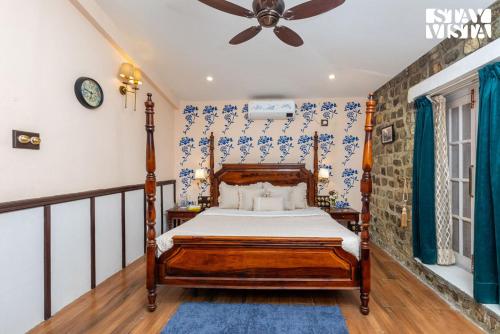 a bedroom with a bed and a ceiling fan at The Enchanted Forest with ATV Bike, Pet Friendly at Jim Corbett by StayVista in Kota Bāgh