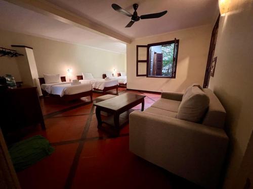a living room with a couch and a ceiling fan at Natural Relax Villa in Siem Reap