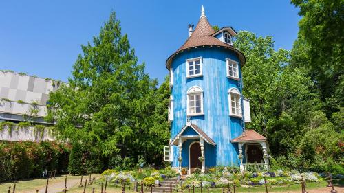 a blue tower in the middle of a garden at Toyoko Inn Tokyo Seibu Ikebukuro sen Higashi kurume eki Nishi guchi in Higashikurume