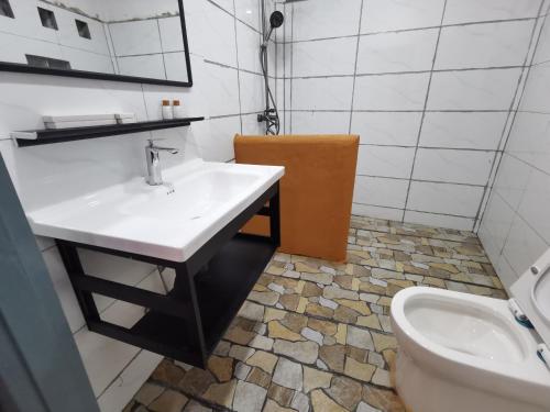 a bathroom with a sink and a toilet at Fortunate angle guesthouse 乐居 in Luang Prabang