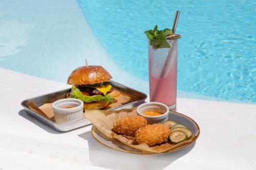 a tray of food with a sandwich and a drink at Le Pirate Beach Club Nusa Ceningan - Adults Only in Nusa Lembongan