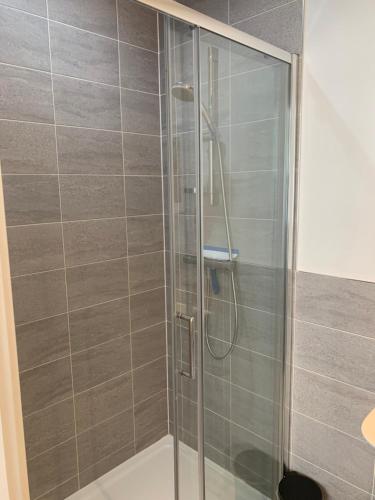 a shower with a glass door in a bathroom at The Chestnuts in Winscombe