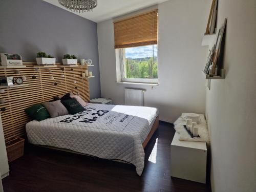 a small bedroom with a bed and a window at Apartament Kocham Gdańsk in Gdańsk