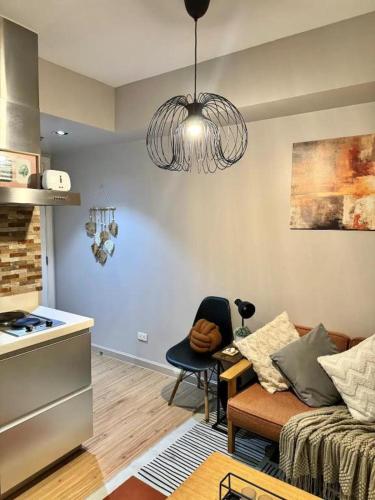 a living room with a couch and a kitchen at Azure Urban Residences Beach and Resort by Vookley in Manila