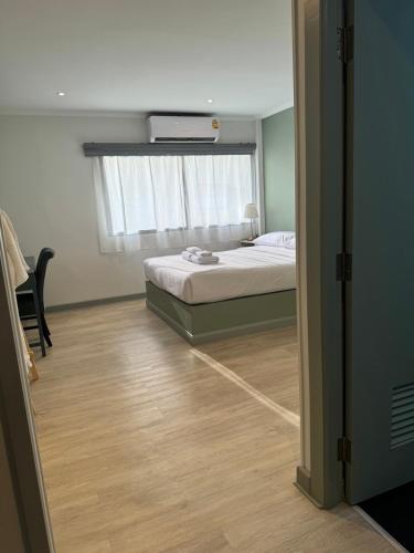 a small bedroom with a bed and a window at O'Shea's Sukhumvit Bangkok in Khlong Toei
