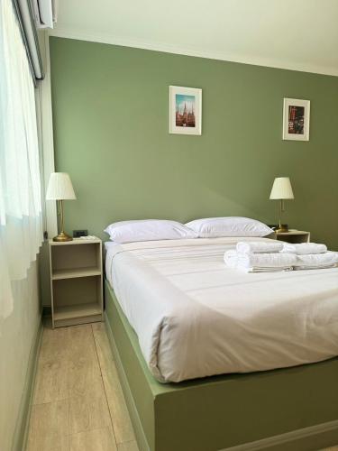 a bedroom with a large bed with white sheets and pillows at O'Shea's Sukhumvit Bangkok in Khlong Toei