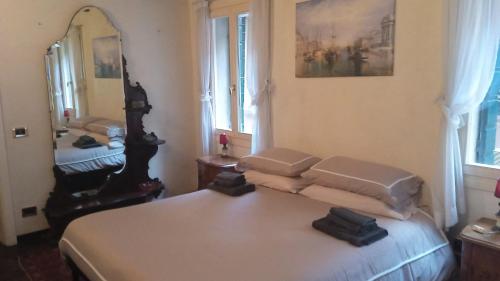 a bedroom with a bed and a large mirror at Ca' Toletta in Venice