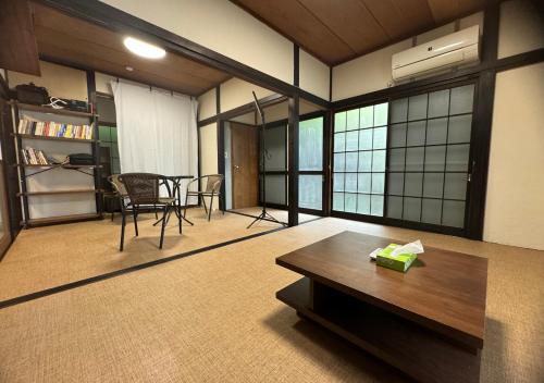 a living room with a table and a dining room at JapaneseTraditional house【Zushi Kotsubo ONDa】 in Zushi