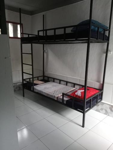 a bedroom with two bunk beds in a room at ATB Hostel in Lovina