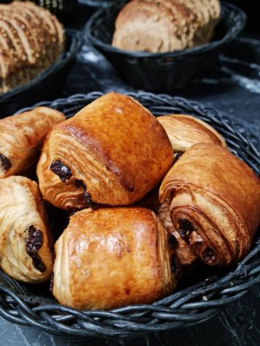 a bunch of pastries in a basket at Logis Hôtel Atrium Epinal Golbey in Épinal