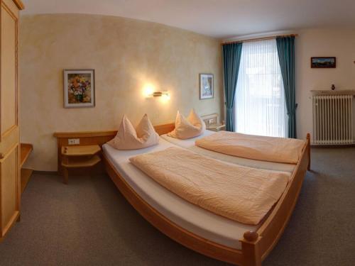 a hotel room with two beds and a desk at Lovely holiday home near ski-lift in Inzell